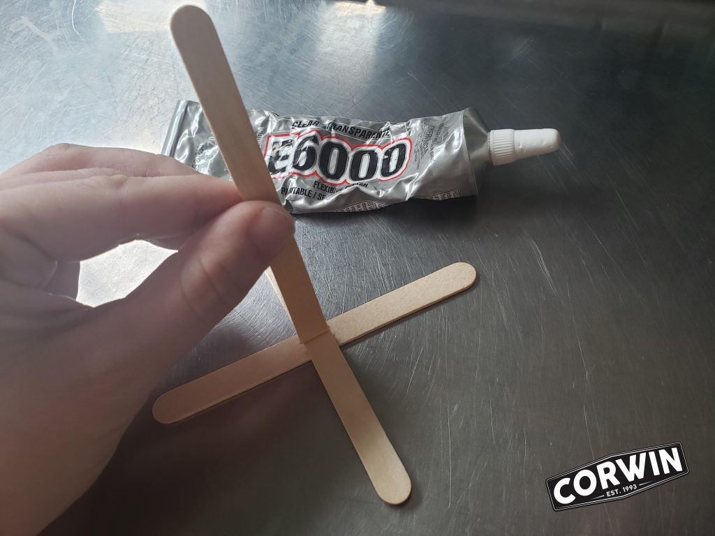 Glue Popsicle stick to "X"